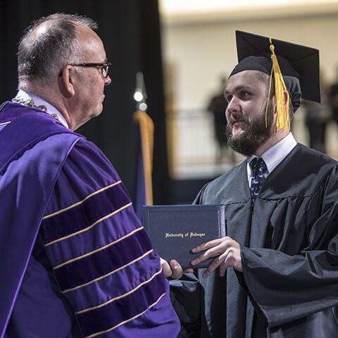 Student receiving diploma at graduation